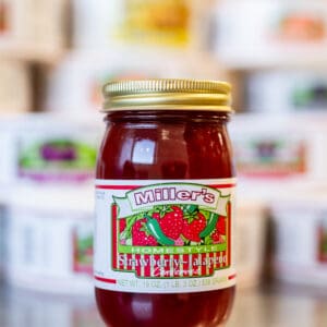 A jar of tomato sauce sitting on top of a counter.