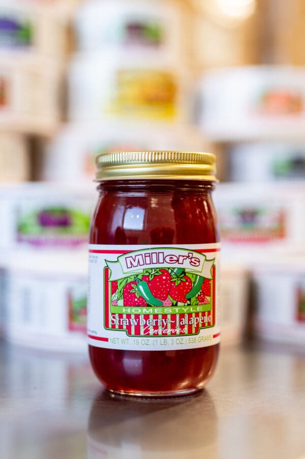 A jar of tomato sauce sitting on top of a counter.