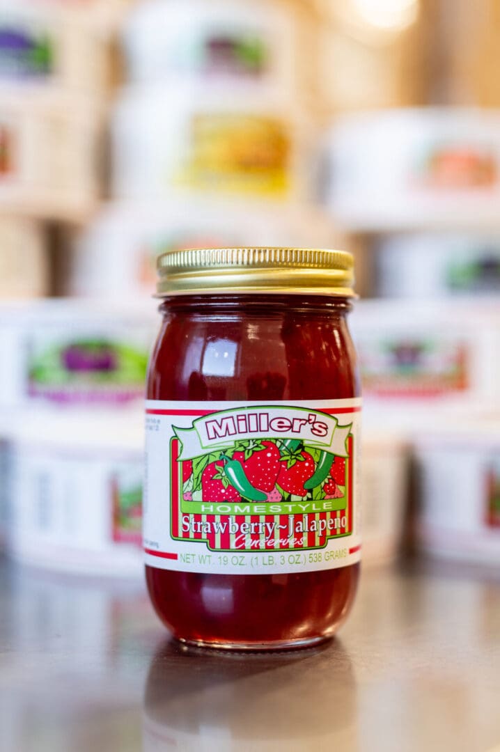 A jar of tomato sauce sitting on top of a counter.