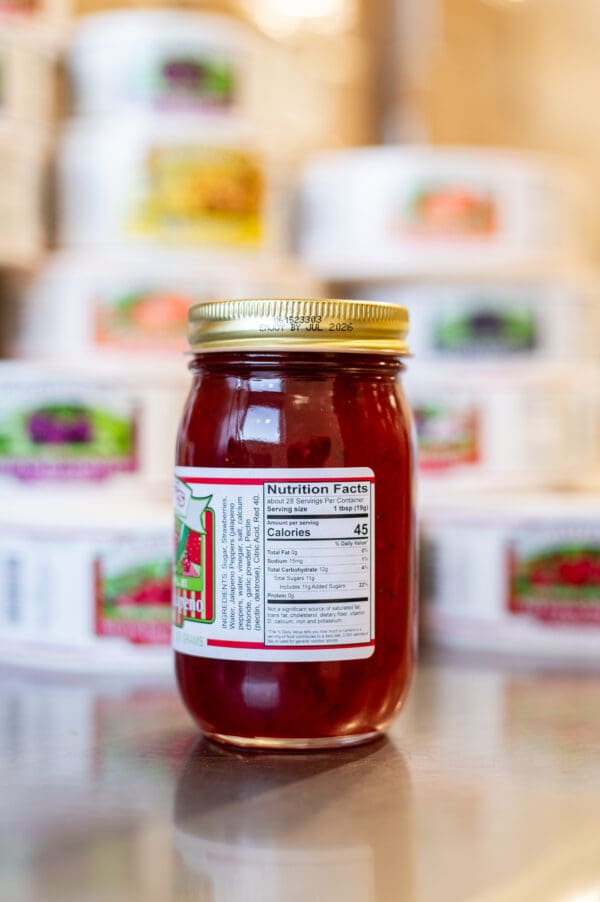 A jar of jelly sitting on top of a table.