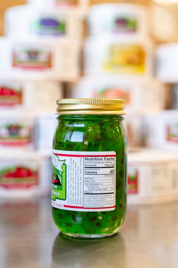 A jar of pickles sitting on top of a counter.