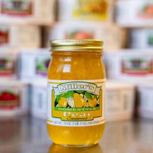 A jar of honey sitting on top of a table.