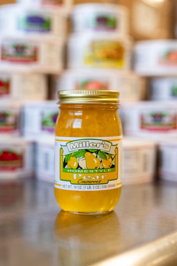 A jar of honey sitting on top of a table.