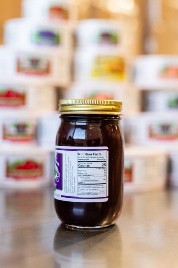 A jar of jelly sitting on top of a table.