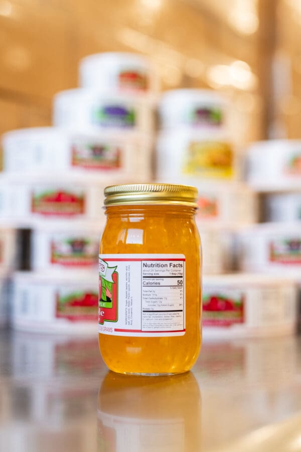 A jar of honey sitting on top of a table.