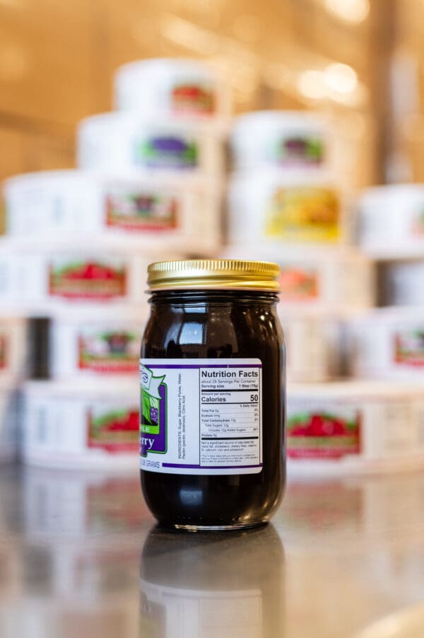 A jar of jelly sitting on top of a table.