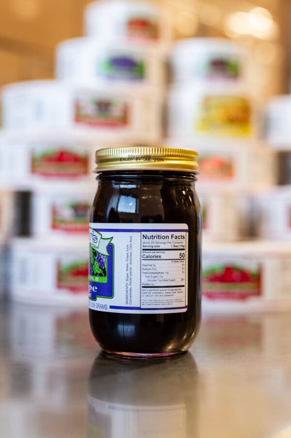 A jar of jelly sitting on top of a table.