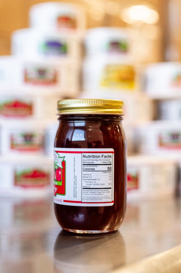 A jar of jelly sitting on top of a table.