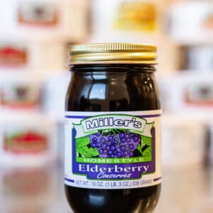A jar of elderberry conserved on the counter.