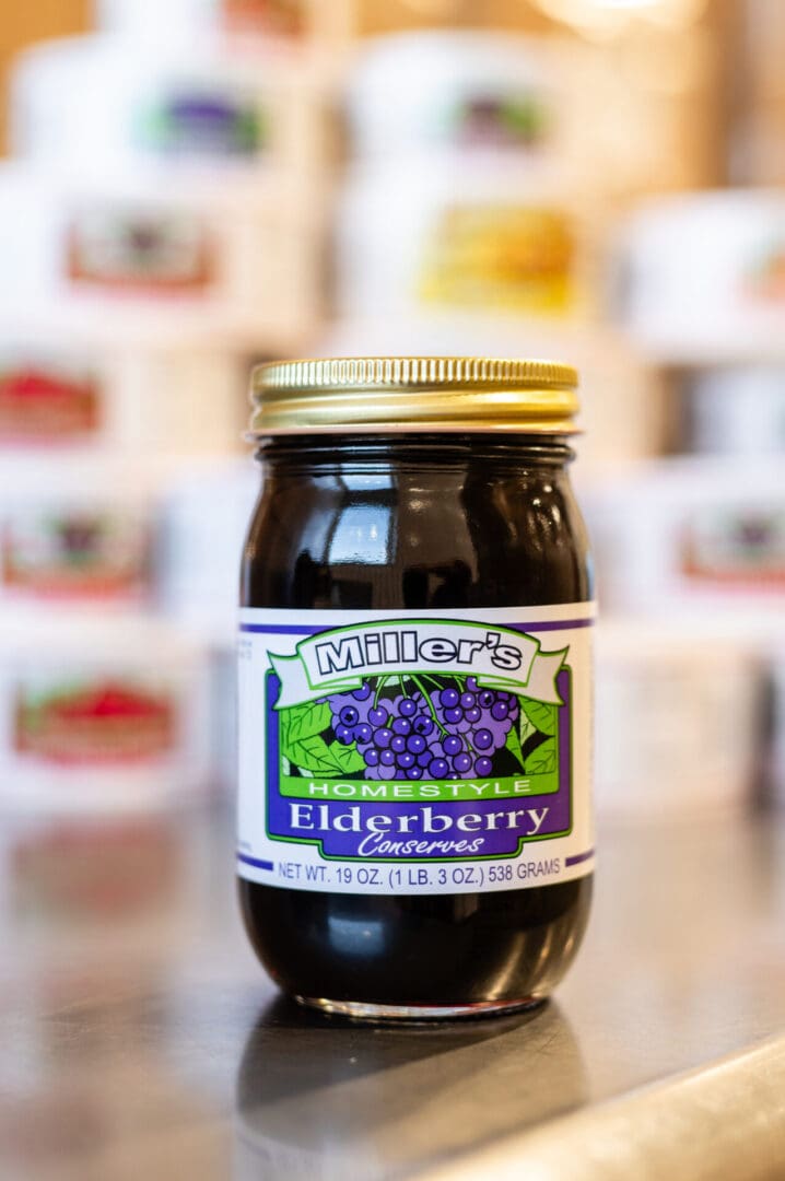 A jar of elderberry conserved on the counter.