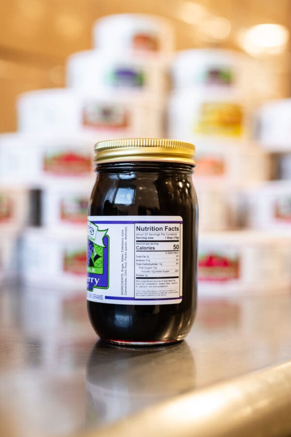 A jar of jelly sitting on top of a table.