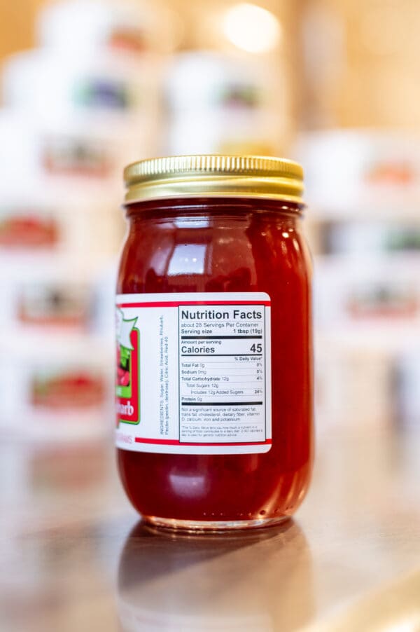 A jar of ketchup with the label on it.