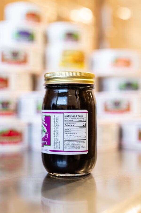 A jar of jelly sitting on top of a table.