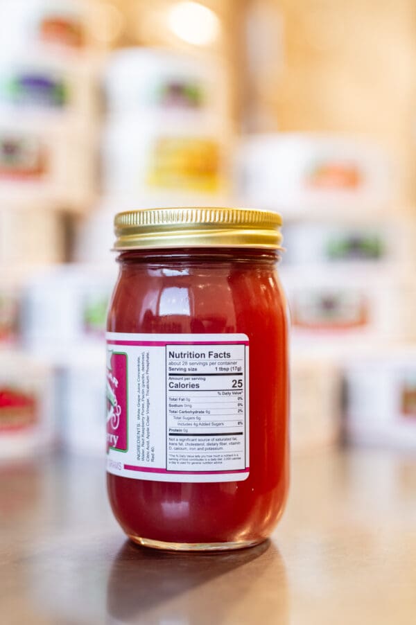 A jar of tomato sauce with a gold lid.