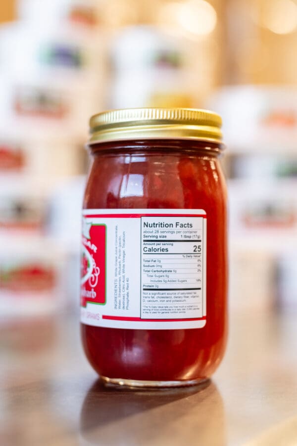 A jar of ketchup with the label on it.