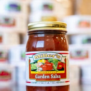 A jar of salsa sitting on top of a table.