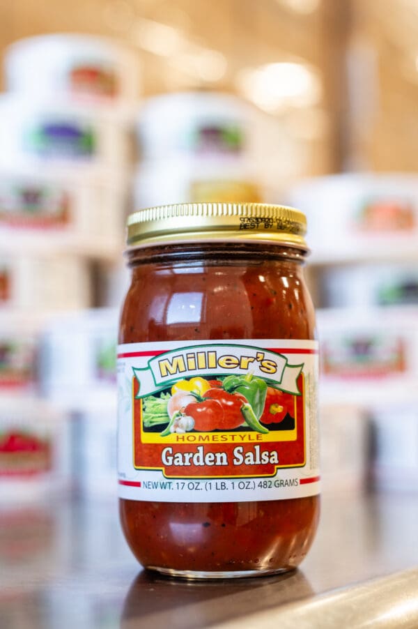 A jar of salsa sitting on top of a table.