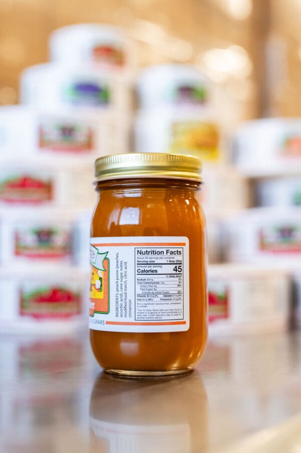 A jar of honey sitting on top of a table.