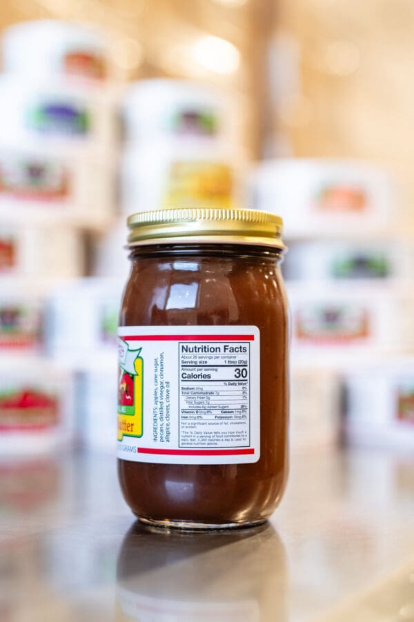 A jar of peanut butter on top of a table.