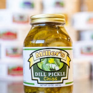 A jar of pickles sitting on top of a counter.