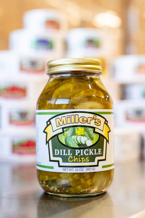 A jar of pickles sitting on top of a counter.