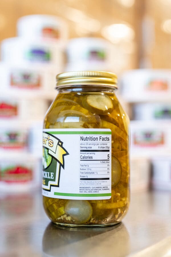 A jar of pickles sitting on top of a table.