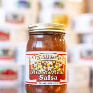 A jar of salsa sitting on top of a counter.