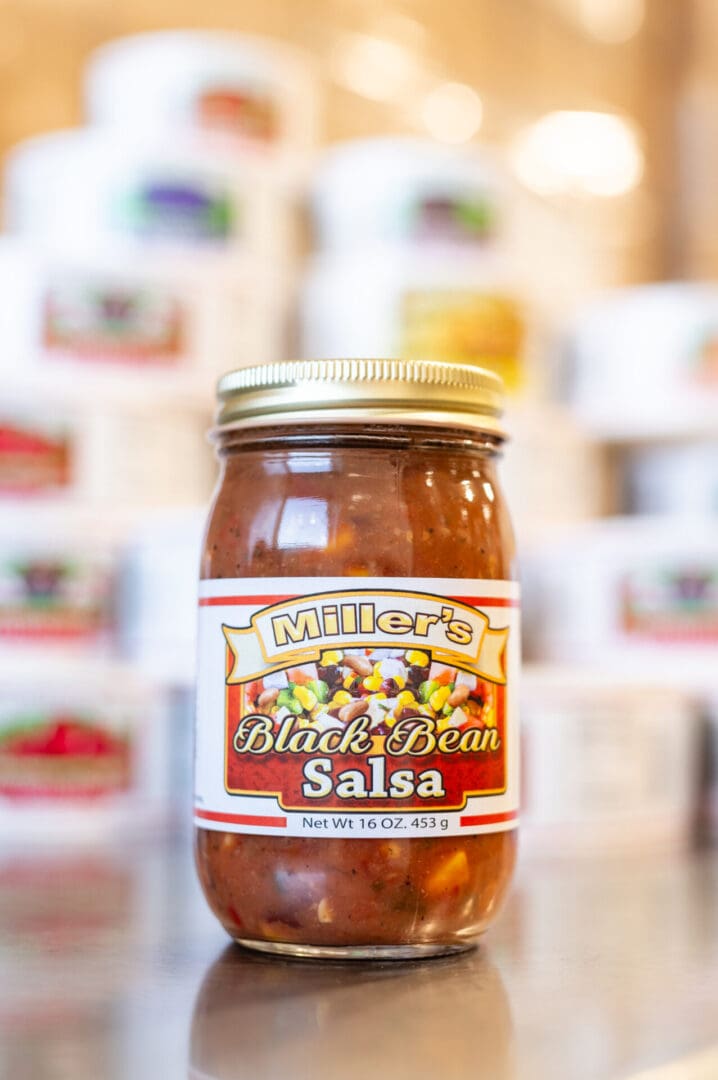 A jar of salsa sitting on top of a counter.