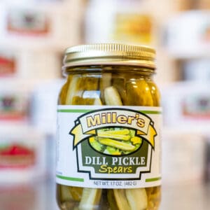 A jar of pickles sitting on top of a counter.