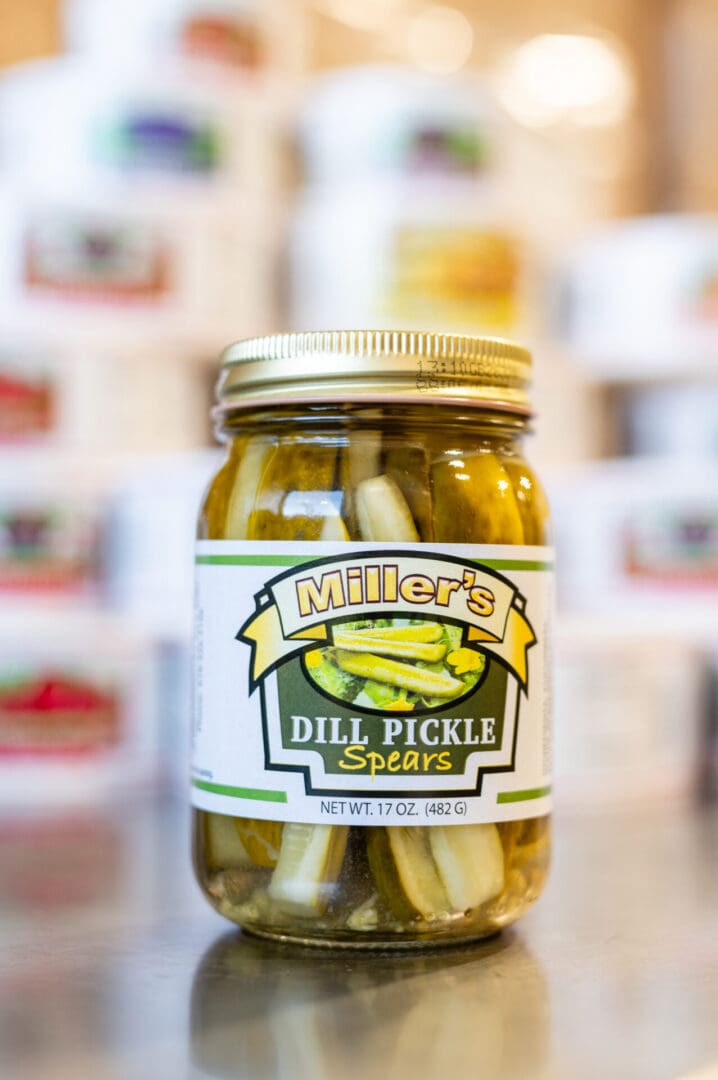 A jar of pickles sitting on top of a counter.