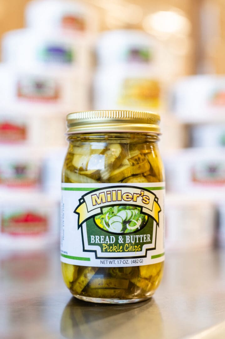 A jar of pickles sitting on top of a counter.