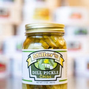 A jar of pickles sitting on top of a counter.