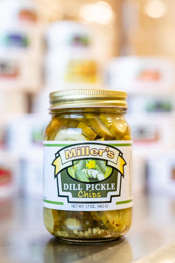 A jar of pickles sitting on top of a counter.