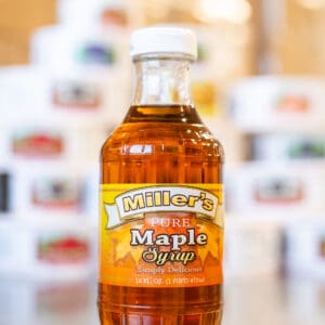 A bottle of maple syrup sitting on top of a table.