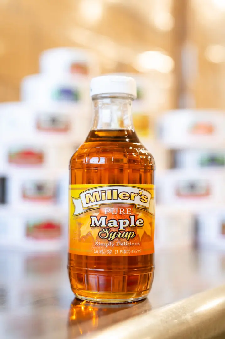 A bottle of maple syrup sitting on top of a table.