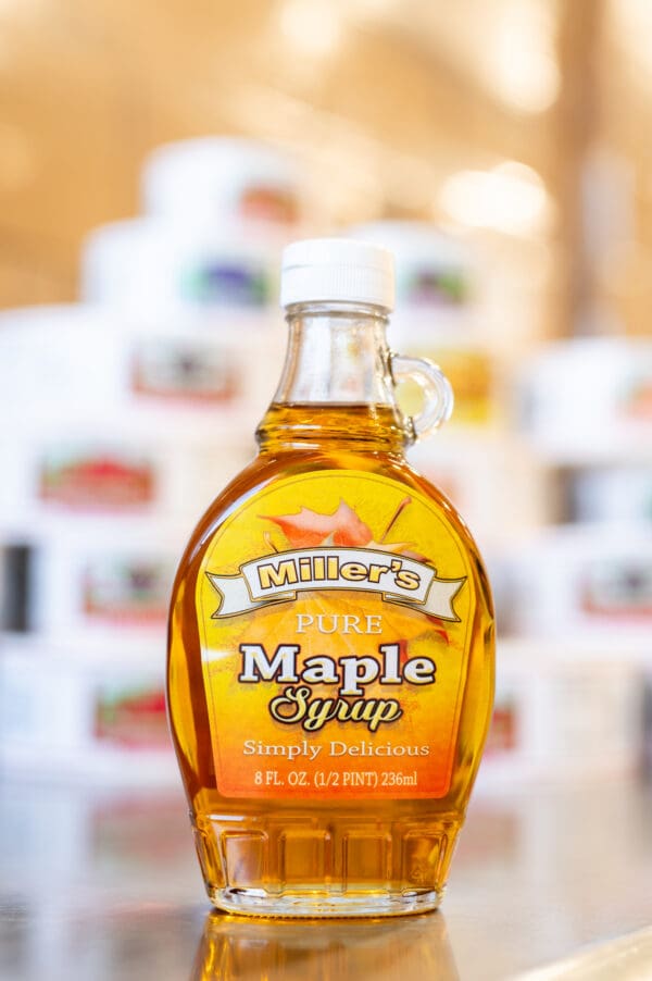 A bottle of maple syrup sitting on top of a table.