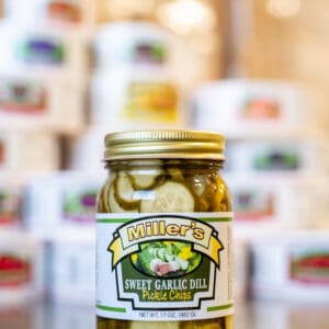 A jar of pickles sitting on top of a counter.