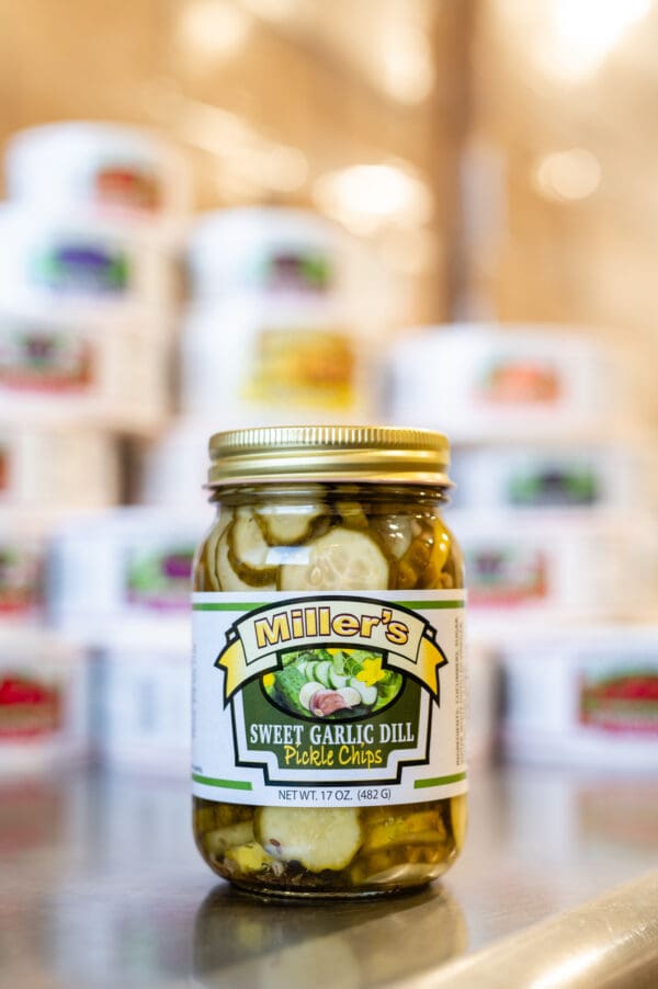 A jar of pickles sitting on top of a counter.