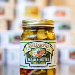 A jar of pickles sitting on top of a counter.