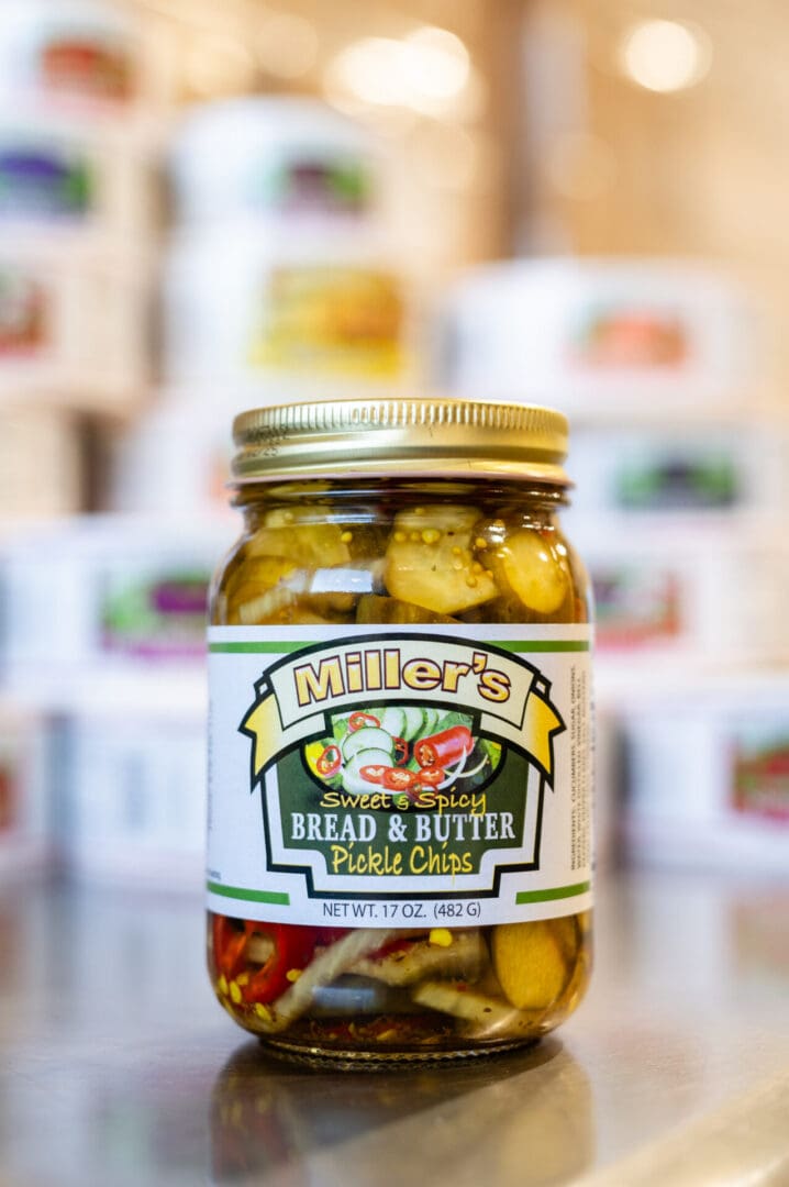 A jar of pickles sitting on top of a counter.