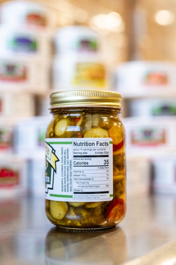 A jar of pickles sitting on top of a counter.