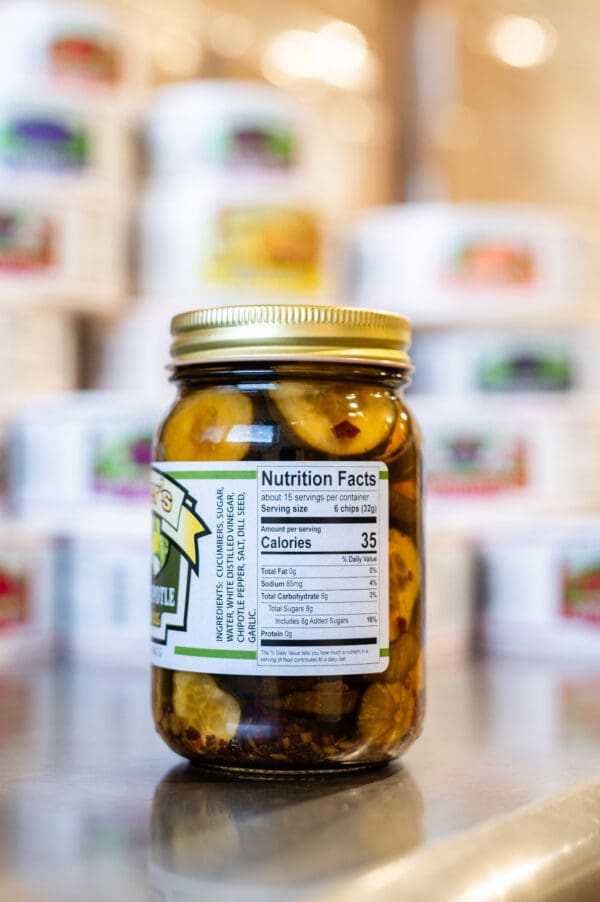 A jar of pickles sitting on top of a table.