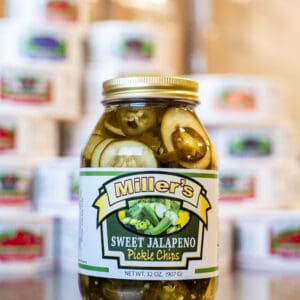A jar of pickles sitting on top of a table.