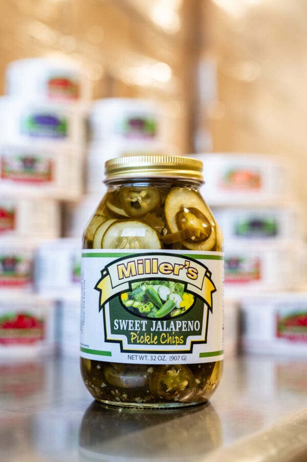 A jar of pickles sitting on top of a table.