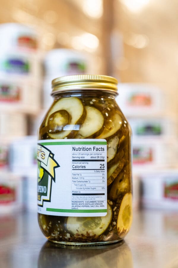 A jar of pickles sitting on top of a table.