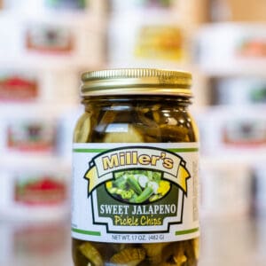 A jar of pickles sitting on top of a counter.