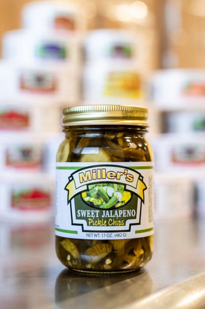 A jar of pickles sitting on top of a counter.