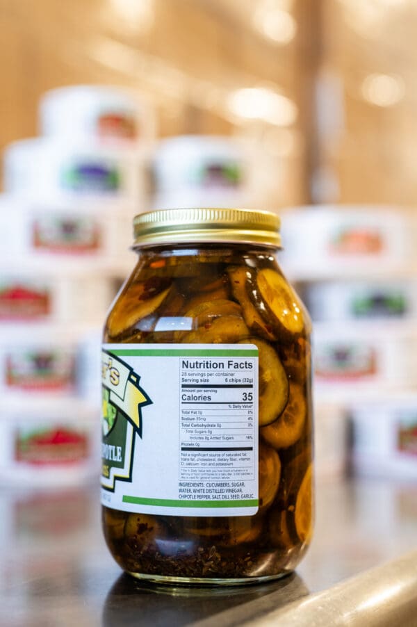 A jar of pickles sitting on top of a counter.