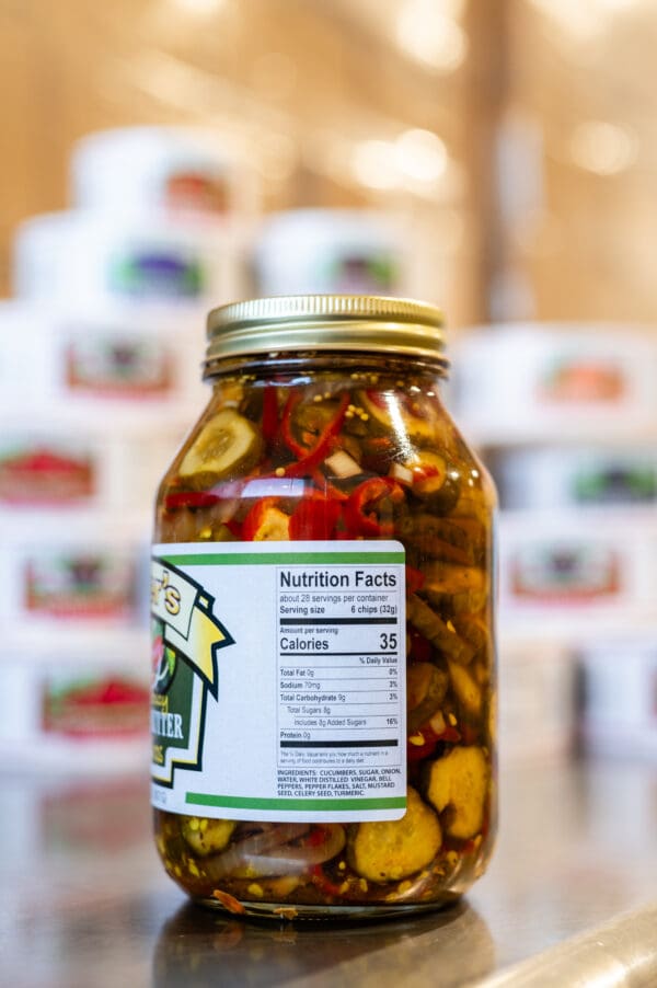 A jar of pickles sitting on top of a counter.