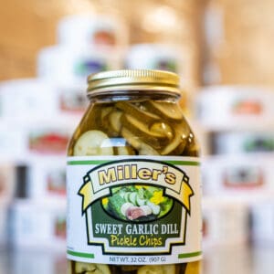A jar of pickles sitting on top of a table.